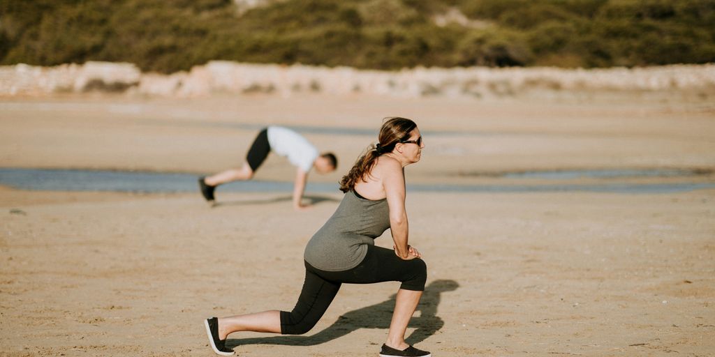 woman wearing grey tank top doing exercise