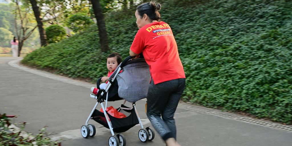 a woman pushing a stroller with a child in it
