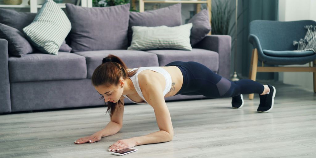 a woman is doing push ups on the floor
