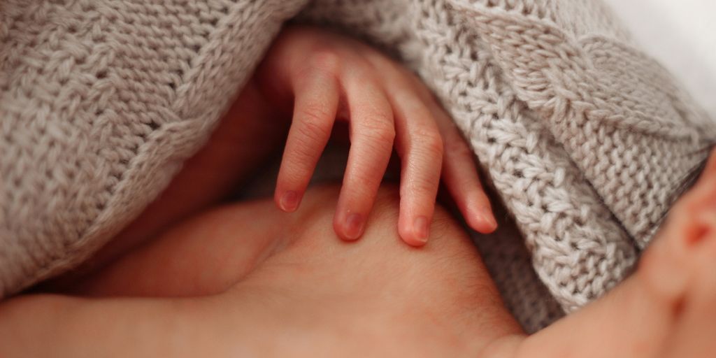 a close up of a baby wrapped in a blanket
