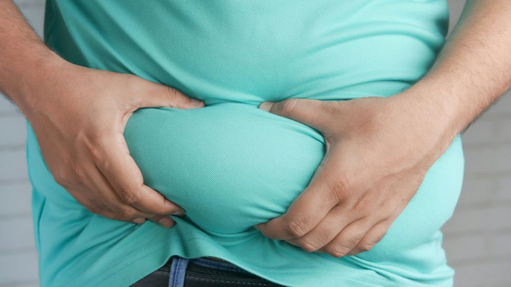 a man holding his stomach with his hands