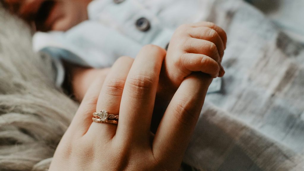 person wearing silver diamond ring
